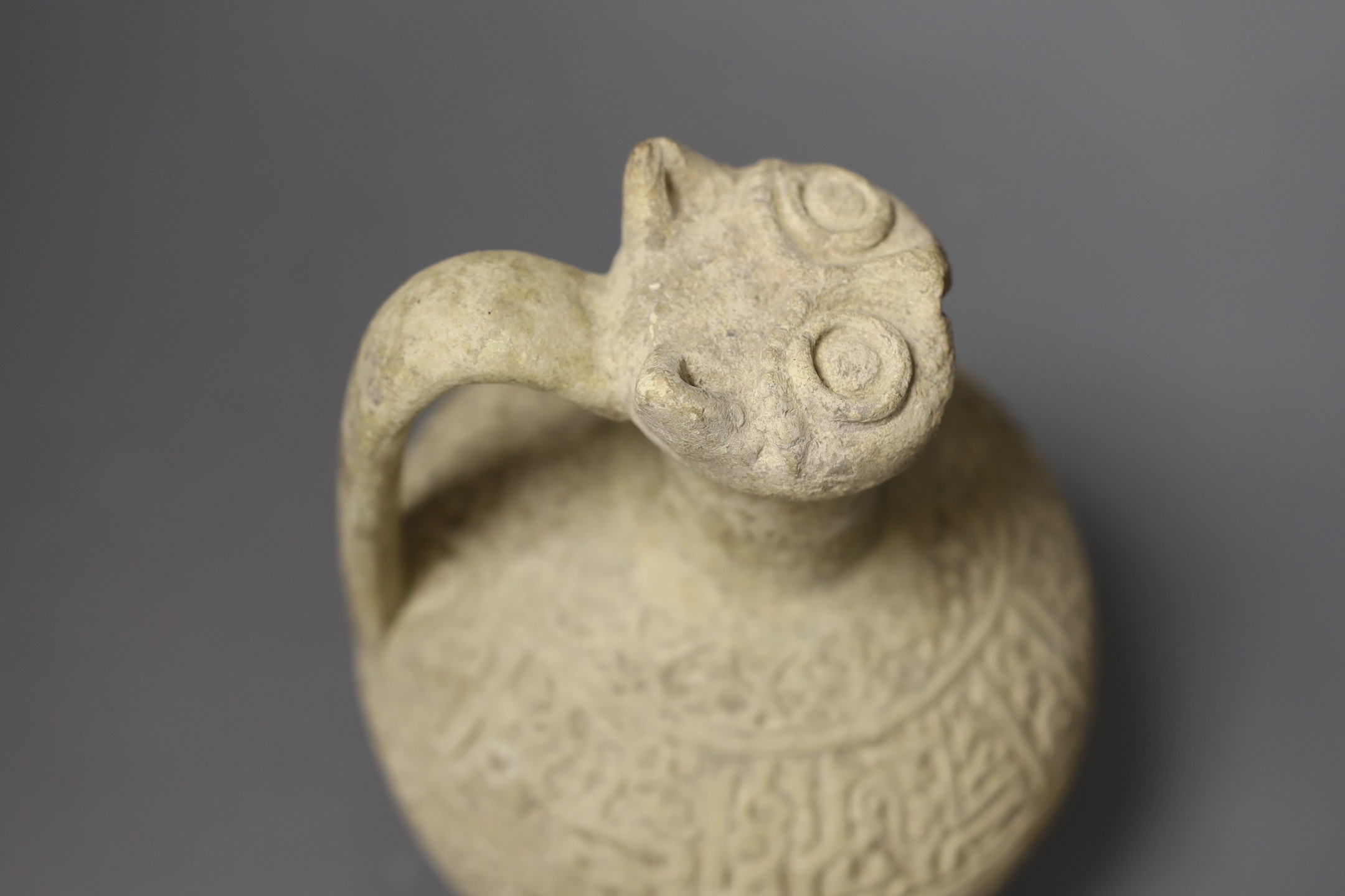 Three Islamic terracotta jugs and a strainer, Middle Eastern, possibly 12th century, tallest 24cm